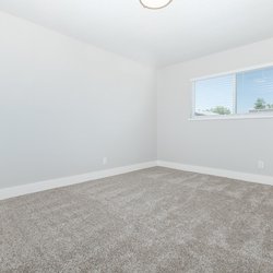 Carpeted primary bedroom at Carlson Apartments, located in Colorado Springs, CO